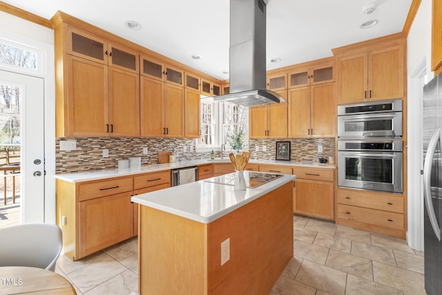 kitchen featuring light countertops, backsplash, island exhaust hood, and appliances with stainless steel finishes