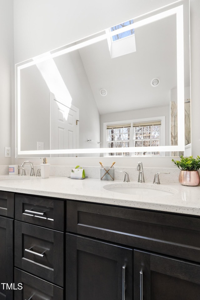 full bath featuring double vanity and a sink