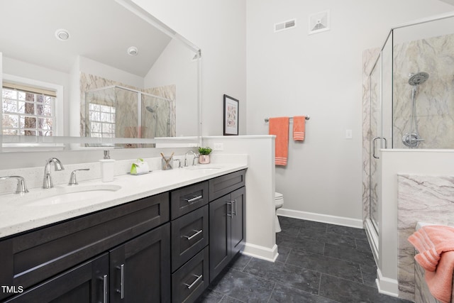 full bath featuring a sink, visible vents, a shower stall, and double vanity