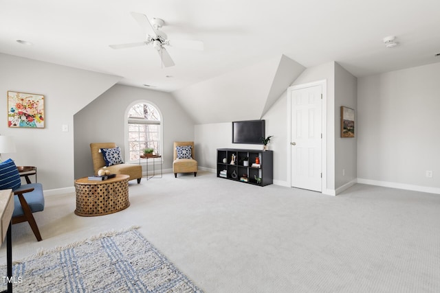 living area with vaulted ceiling, baseboards, carpet floors, and ceiling fan