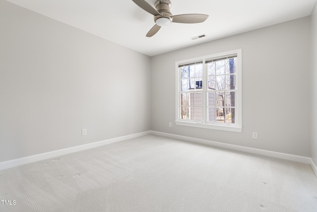 unfurnished room featuring ceiling fan, baseboards, visible vents, and light carpet