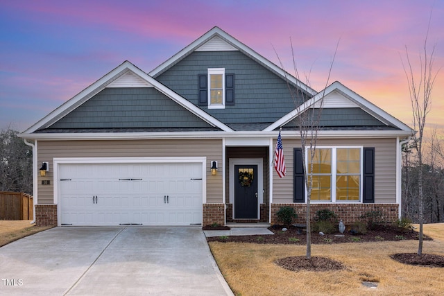 craftsman inspired home featuring brick siding, an attached garage, and driveway