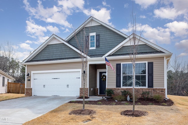 craftsman inspired home featuring concrete driveway, a garage, fence, and brick siding