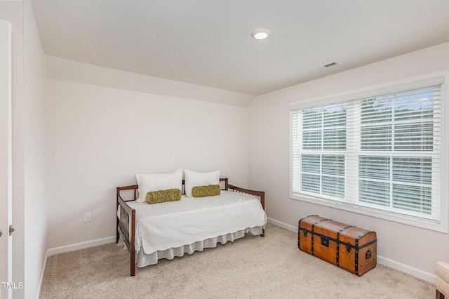 carpeted bedroom featuring visible vents and baseboards