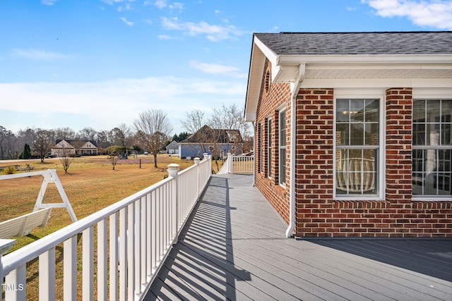 wooden deck with a lawn