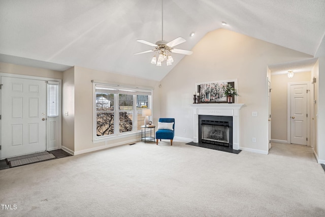 living area with baseboards, a fireplace with flush hearth, ceiling fan, and carpet flooring