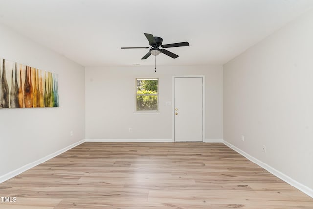 empty room with baseboards, light wood-style flooring, and ceiling fan