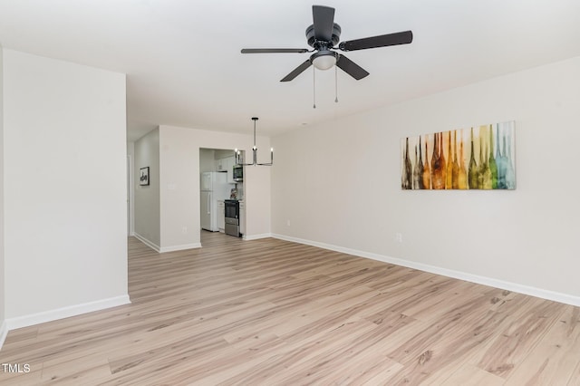 unfurnished living room with light wood-style floors, baseboards, and ceiling fan with notable chandelier