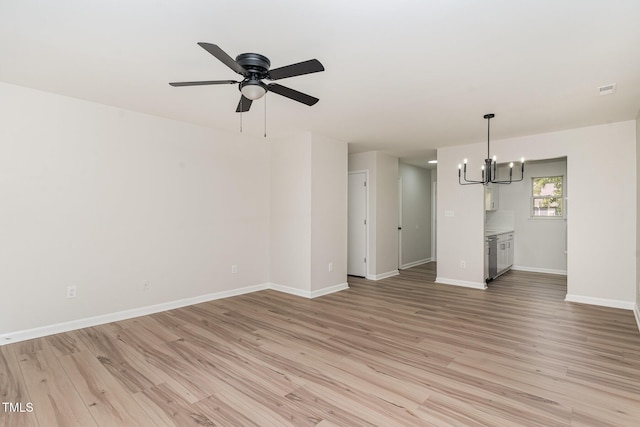 unfurnished living room with baseboards, ceiling fan with notable chandelier, and light wood-style flooring