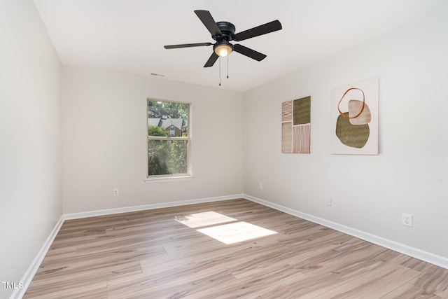unfurnished room with light wood-style floors, a ceiling fan, baseboards, and visible vents