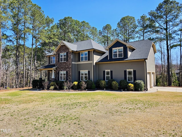 view of front of property featuring a garage and a front lawn