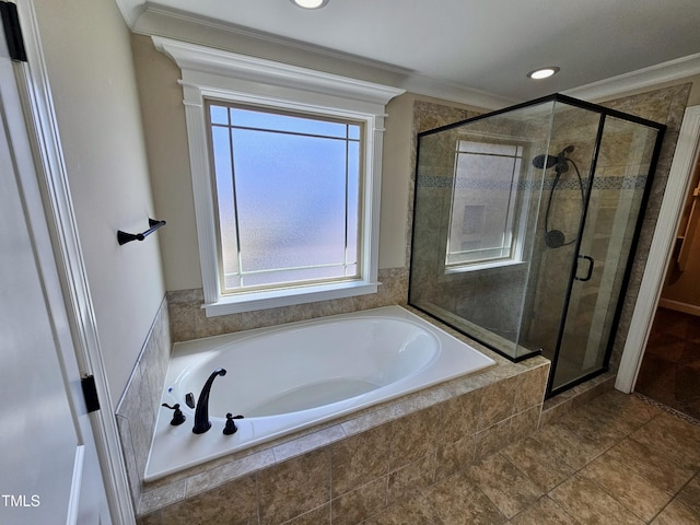 bathroom featuring a stall shower, ornamental molding, and a bath