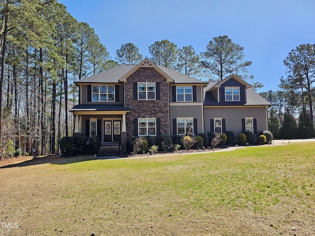 view of front of house with brick siding and a front lawn