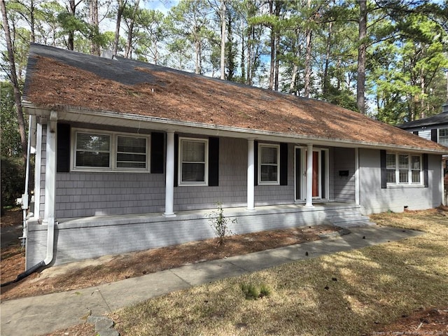 ranch-style home featuring brick siding and a porch