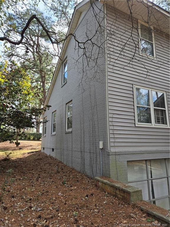 view of home's exterior with crawl space