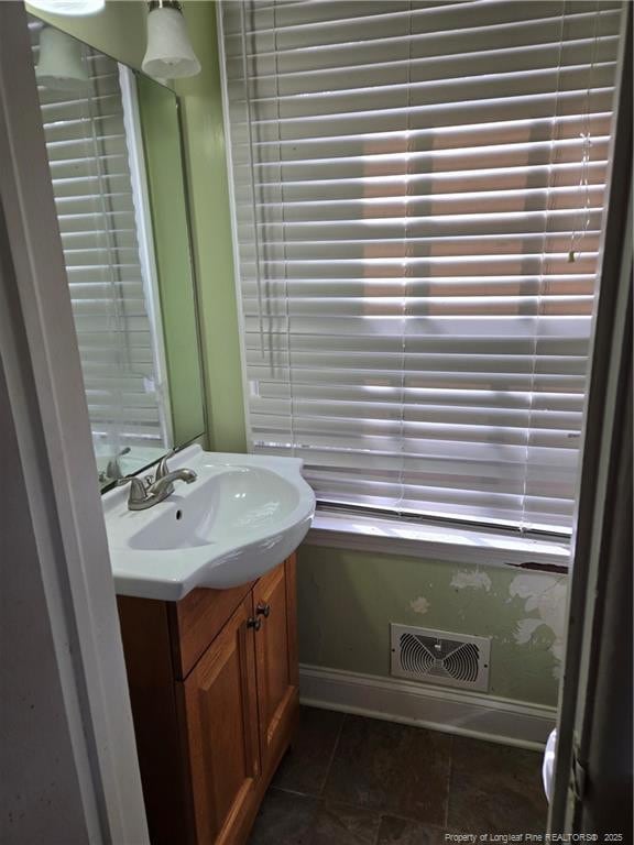 bathroom with tile patterned flooring, visible vents, vanity, and baseboards