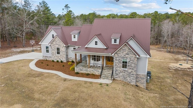 craftsman house with metal roof, stone siding, a porch, and a standing seam roof