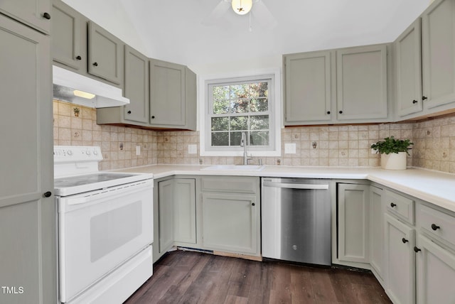 kitchen with under cabinet range hood, light countertops, stainless steel dishwasher, white electric range, and a sink