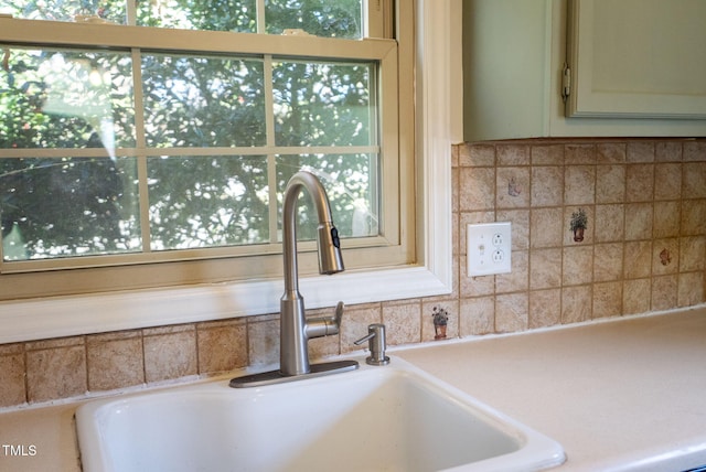 interior details with light countertops and a sink