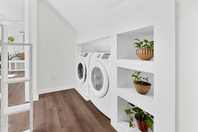 clothes washing area featuring baseboards, dark wood-type flooring, separate washer and dryer, and laundry area