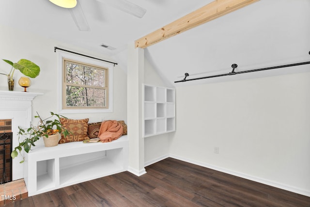 mudroom featuring wood finished floors, visible vents, baseboards, a fireplace, and beamed ceiling