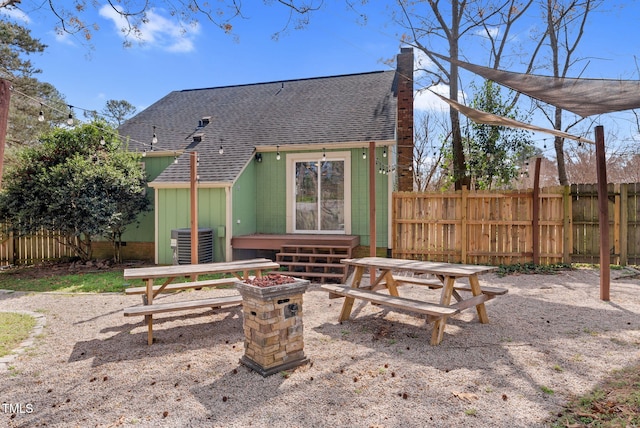 view of patio / terrace with central AC unit and fence