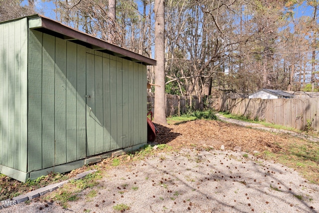 view of shed with a fenced backyard