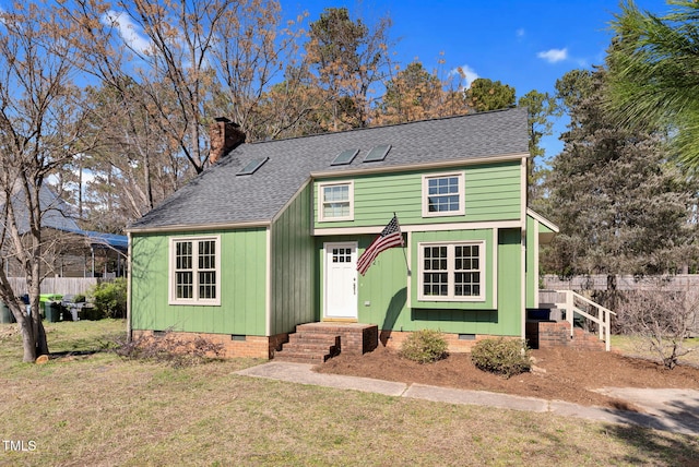 view of front facade featuring a front yard, fence, a shingled roof, a chimney, and crawl space