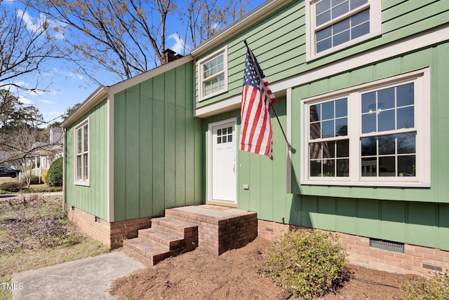 doorway to property featuring crawl space and a chimney