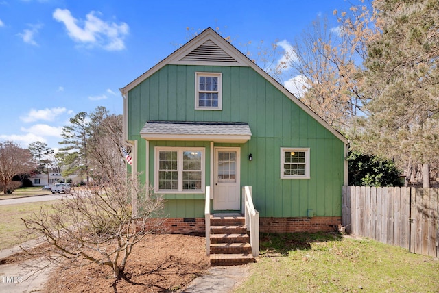 view of front of house featuring crawl space, a shingled roof, and fence