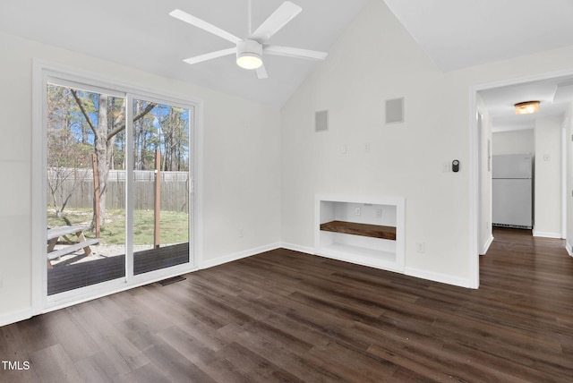 unfurnished living room with vaulted ceiling, dark wood-style floors, visible vents, and a wealth of natural light