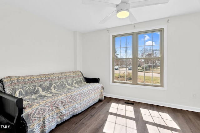 bedroom featuring visible vents, baseboards, wood finished floors, and a ceiling fan