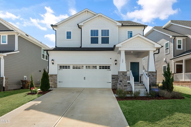 craftsman-style house with stone siding, concrete driveway, a garage, and a front yard