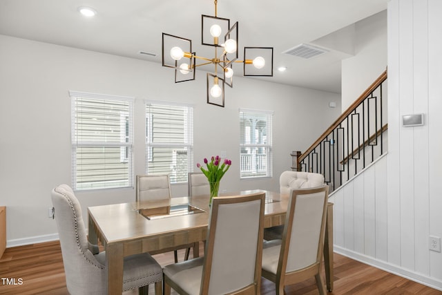 dining room with recessed lighting, visible vents, wood finished floors, and stairway