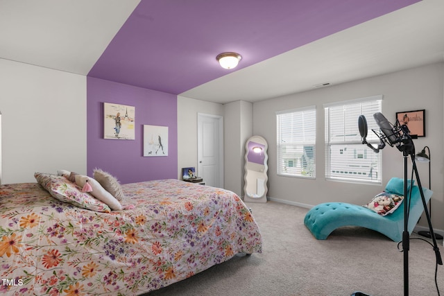 carpeted bedroom featuring visible vents and baseboards