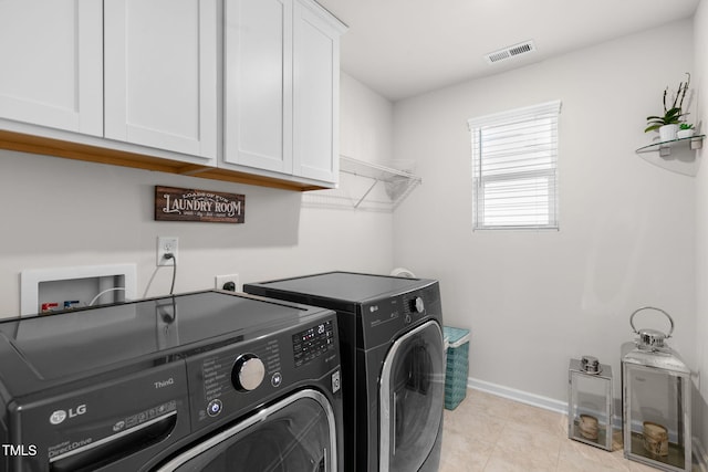 laundry room with baseboards, visible vents, washing machine and clothes dryer, light tile patterned flooring, and cabinet space