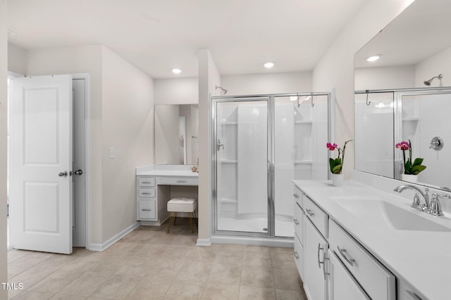 bathroom with tile patterned flooring, a stall shower, vanity, and baseboards