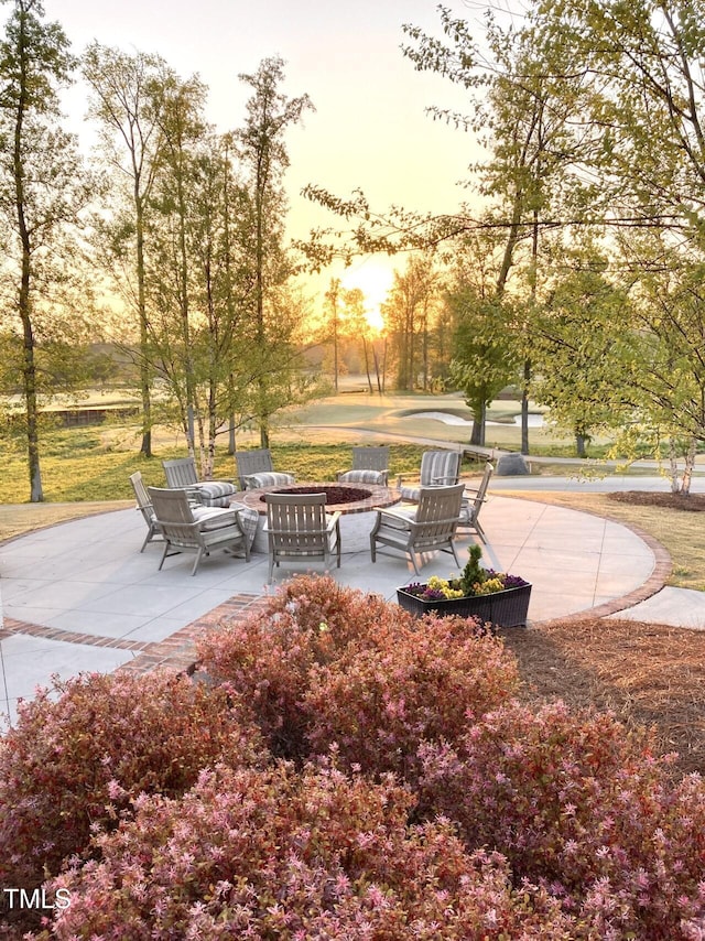 surrounding community with a patio and an outdoor fire pit