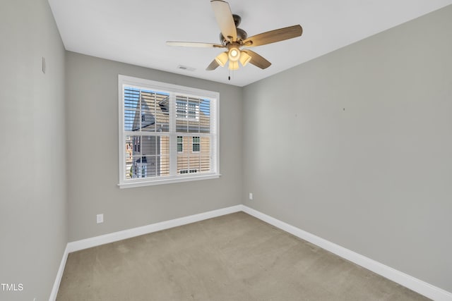 unfurnished room featuring visible vents, a ceiling fan, baseboards, and carpet floors