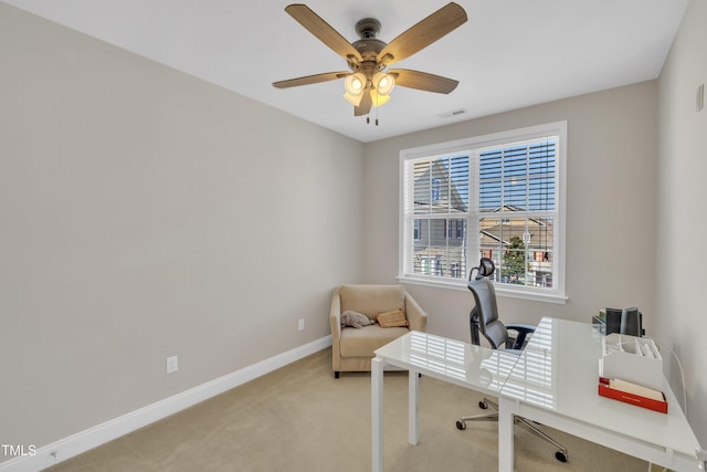 home office featuring visible vents, light colored carpet, baseboards, and ceiling fan