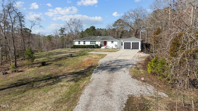 view of front of property with concrete driveway, an attached garage, and a front yard