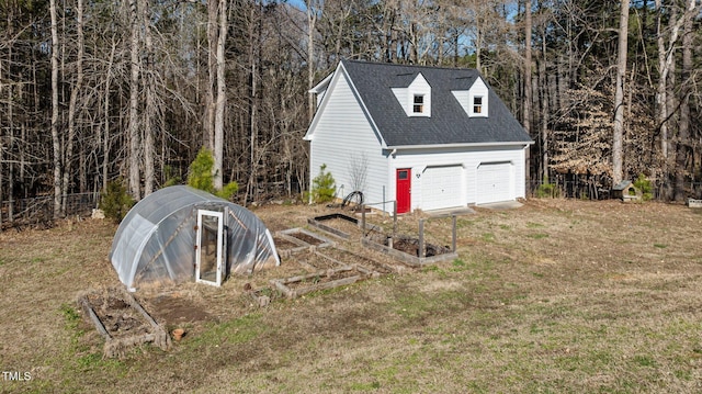 garage featuring a garage and a garden