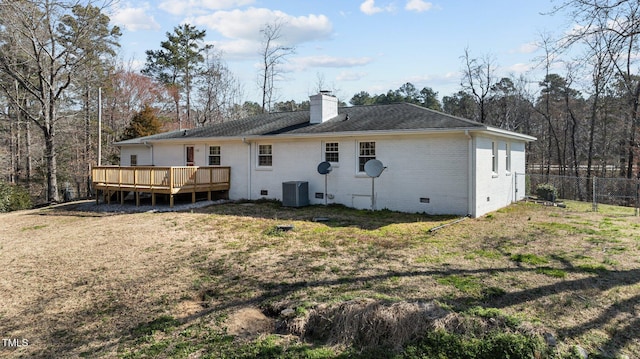 rear view of property featuring a deck, central AC, crawl space, brick siding, and a chimney