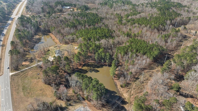 drone / aerial view featuring a wooded view