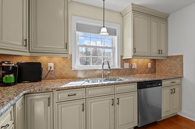 kitchen featuring a sink, cream cabinetry, pendant lighting, dishwasher, and tasteful backsplash