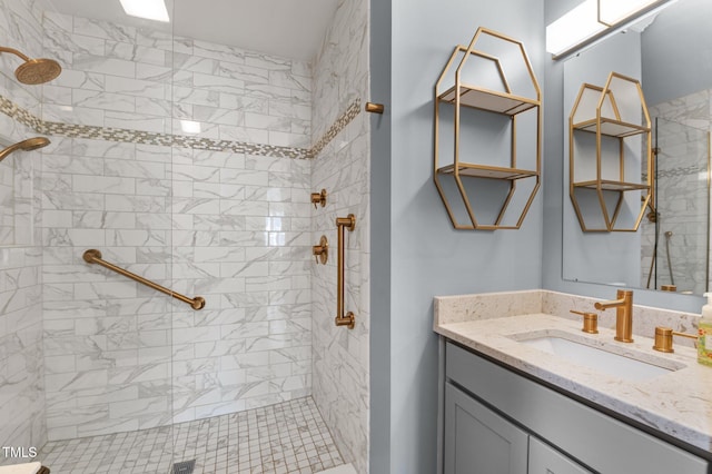 full bathroom with vanity and tiled shower