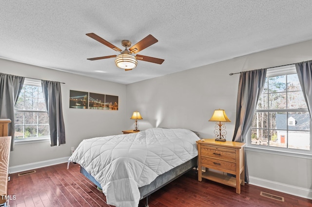 bedroom with hardwood / wood-style flooring, baseboards, and visible vents