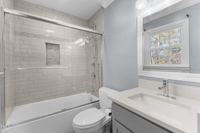 bathroom featuring bath / shower combo with glass door, toilet, and vanity