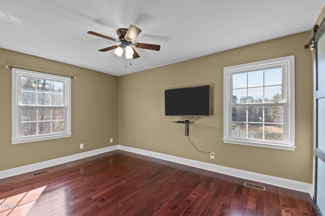 interior space featuring a wealth of natural light, visible vents, and wood-type flooring