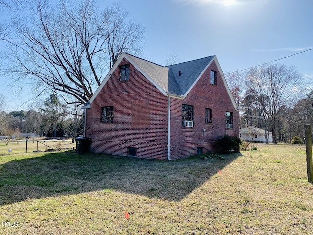 view of home's exterior featuring brick siding, crawl space, and a lawn